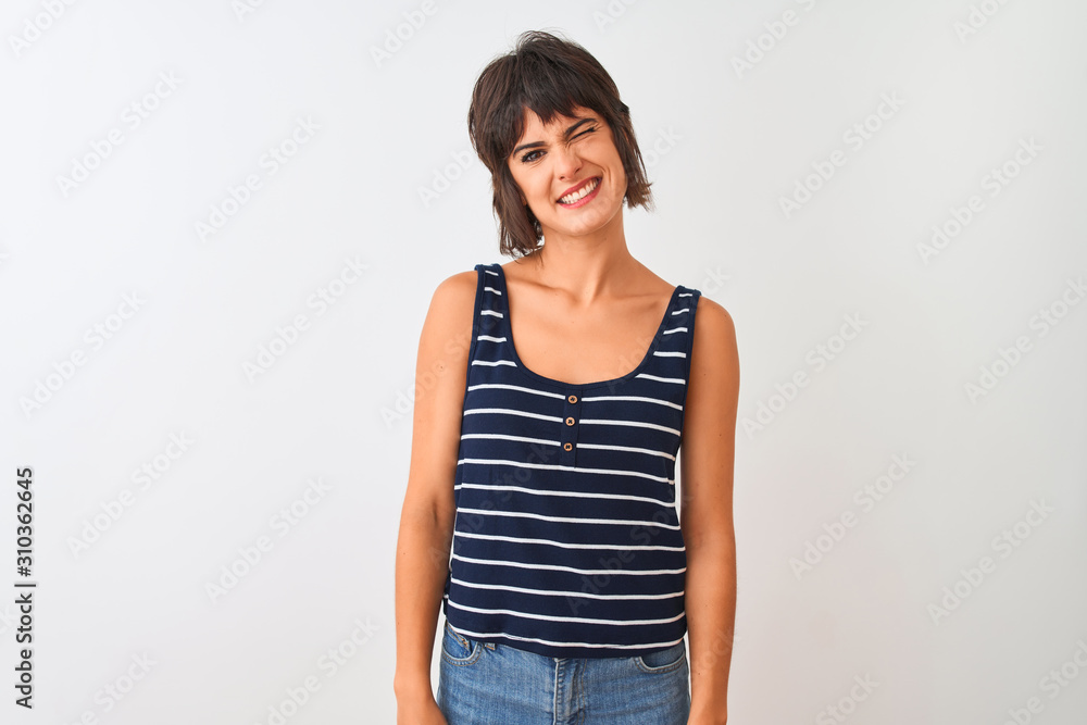 Young beautiful woman wearing striped t-shirt standing over isolated white background winking looking at the camera with sexy expression, cheerful and happy face. Young beautiful woman wearing striped t-shirt standing over isolated white background winking looking at the camera with sexy expression, cheerful and happy face.