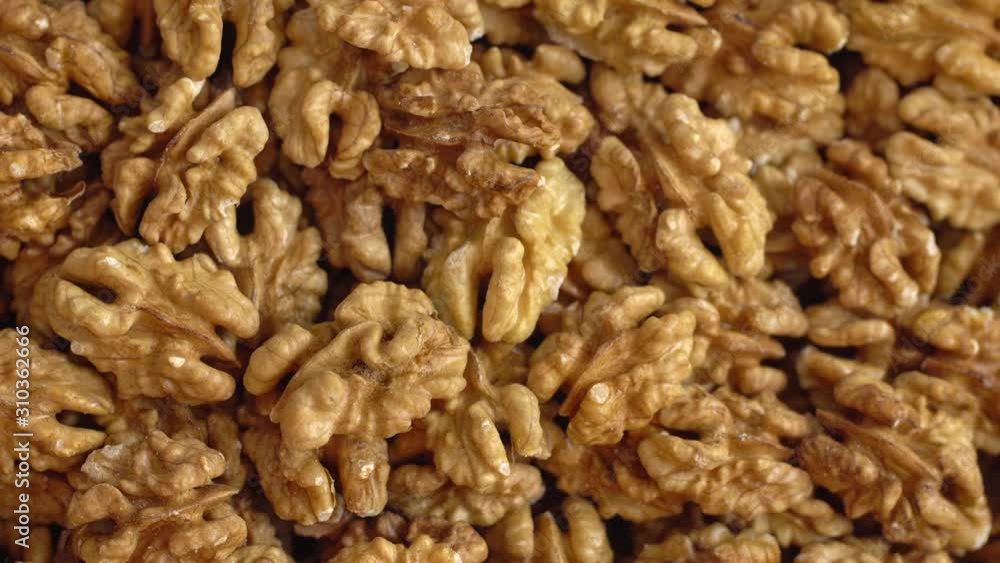 Walnut close up. product rich in minerals and vitamins. Walnut turns in a shot. Walnut kernels rotating. walnut close up lies under beams of the sun. Macro Walnut close up. product rich in minerals and vitamins. Walnut turns in a shot. Walnut kernels rotating. walnut close up lies under beams of the sun. Macro