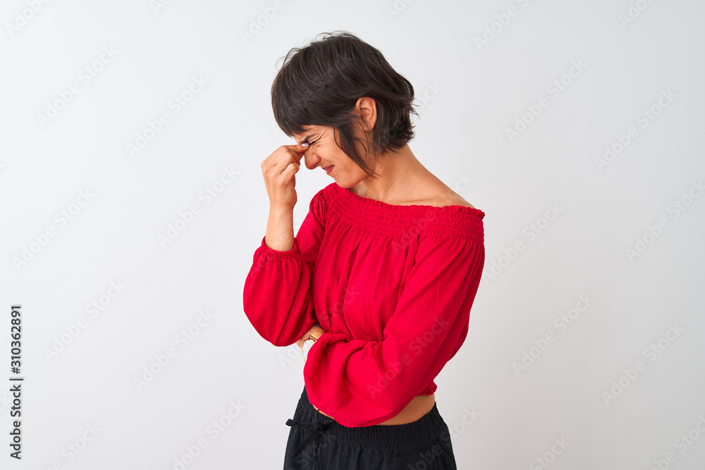 Young beautiful woman wearing red summer t-shirt standing over isolated white background tired rubbing nose and eyes feeling fatigue and headache. Stress and frustration concept. Young beautiful woman wearing red summer t-shirt standing over isolated white background tired rubbing nose and eyes feeling fatigue and headache. Stress and frustration concept.