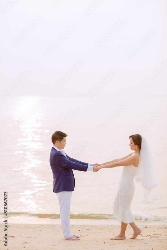 Young asian groom and bride posing and smiling for pre-wedding shot Young asian groom and bride posing and smiling for pre-wedding shot