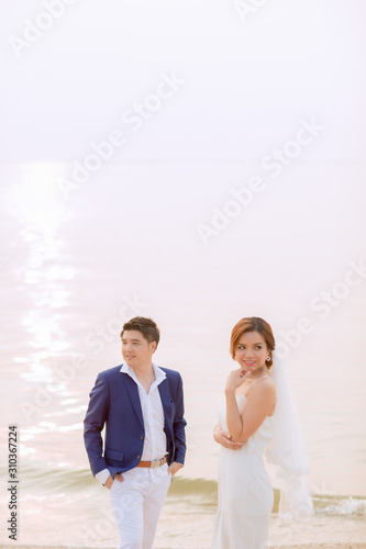 Young asian groom and bride posing and smiling for pre-wedding shot