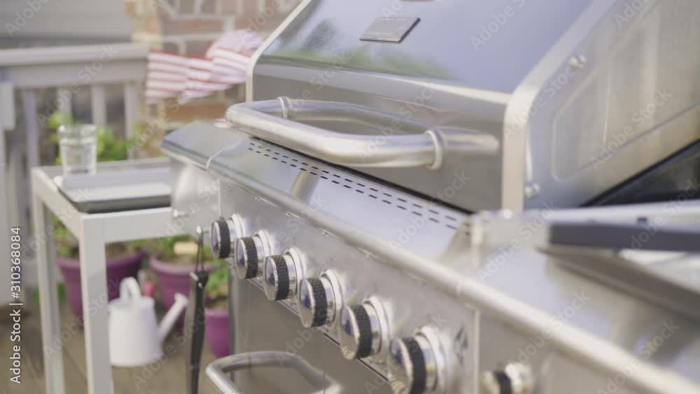 Grilling outdoor on a gas burning grill on the backyard patio. Grilling outdoor on a gas burning grill on the backyard patio.