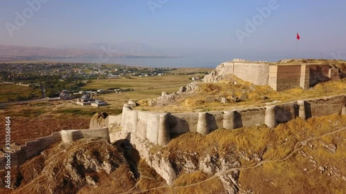 Historical Eastern fortress, Van Castle on rocky hill and mosques photo