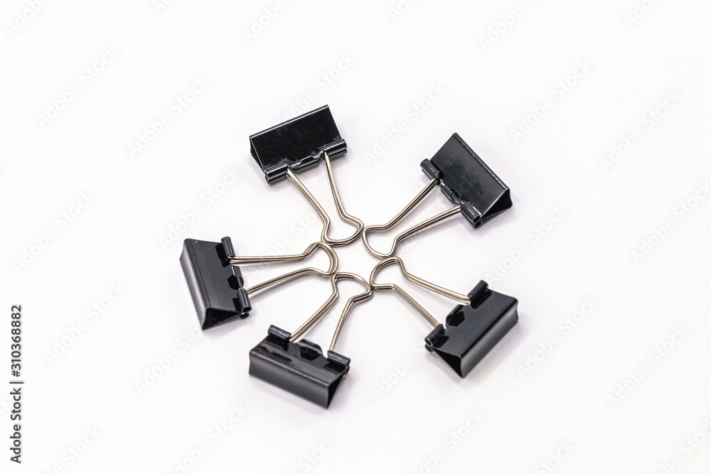 Close up black paper clip isolate on white background.Selective object on white. Close up black paper clip isolate on white background.Selective object on white.