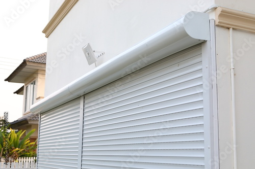Fotografie white roller shutter door closed security in modern house