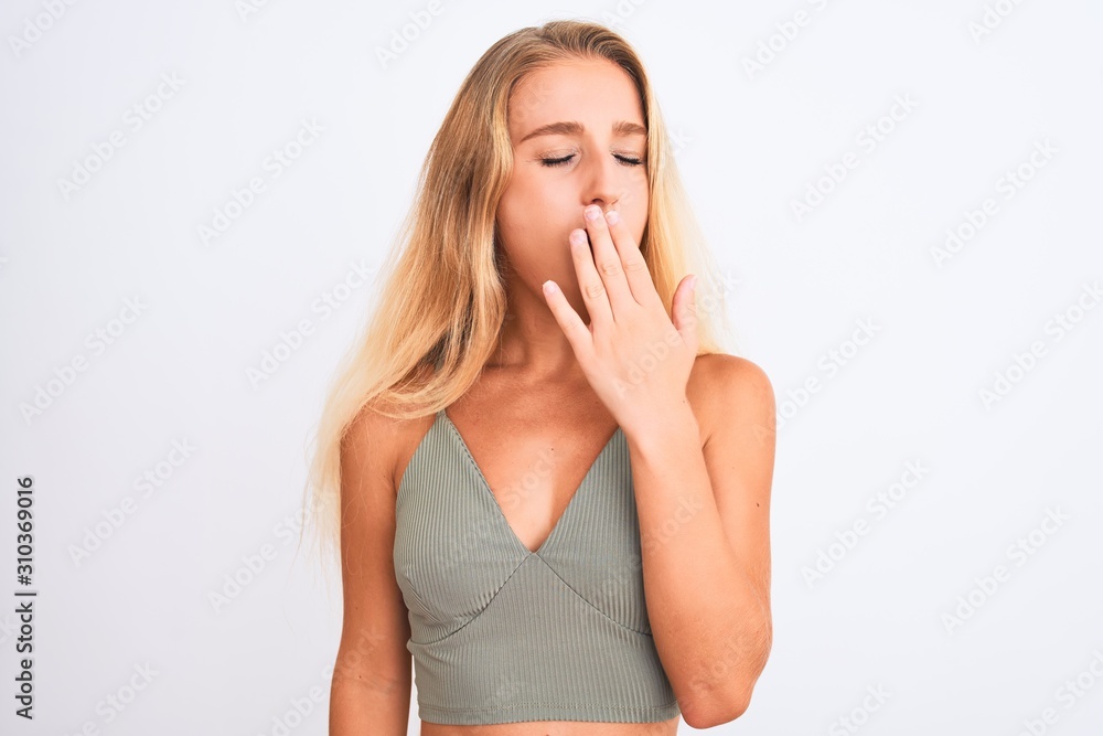 Young beautiful woman wearing casual green t-shirt standing over isolated white background bored yawning tired covering mouth with hand. Restless and sleepiness. Young beautiful woman wearing casual green t-shirt standing over isolated white background bored yawning tired covering mouth with hand. Restless and sleepiness.