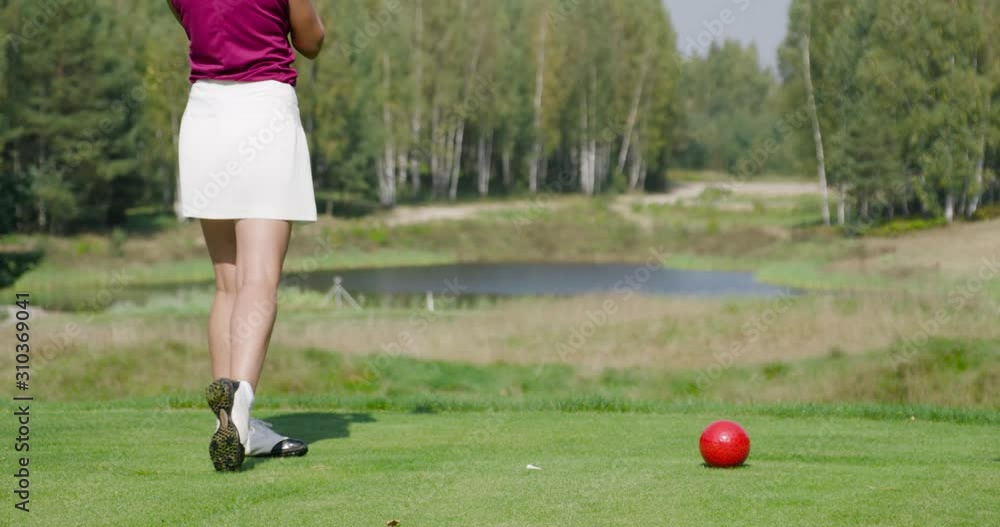 Green park, summer day, woman playing Golf, hits the ball, view of golf course in forest area, green lawn. Green park, summer day, woman playing Golf, hits the ball, view of golf course in forest area, green lawn.