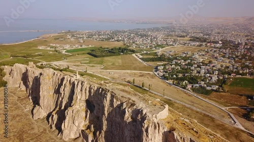 Historical Eastern fortress, Van Castle on rocky hill and mosques photo