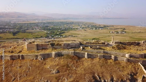 Historical Eastern fortress, Van Castle on rocky hill and mosques photo