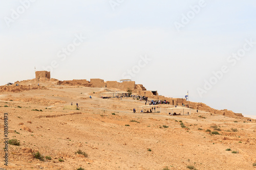 Panorama with ruins of palace and fortress Masada on Judaean Desert rock plateau, Israel