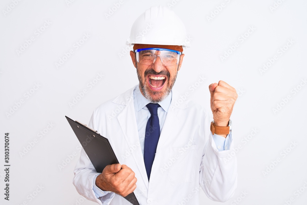 Senior engineer man wearing helmet glasses holding clipboard over isolated white background screaming proud and celebrating victory and success very excited, cheering emotion