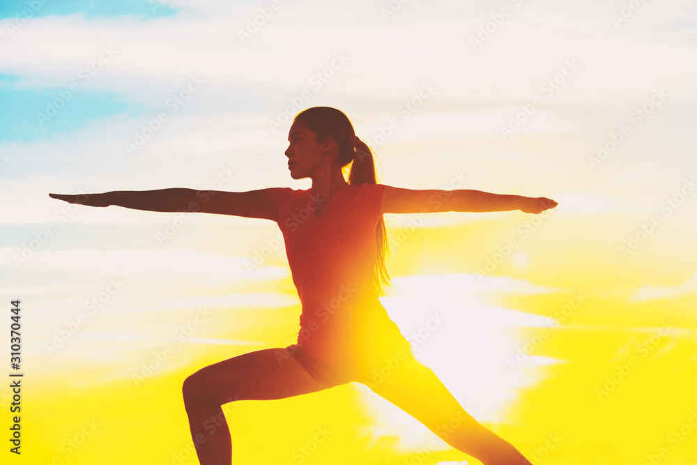 Sun yoga practicing woman training outdoor meditation. Girl silhouette in warrior pose. Healthy lifestyle. Sun yoga practicing woman training outdoor meditation. Girl silhouette in warrior pose. Healthy lifestyle.