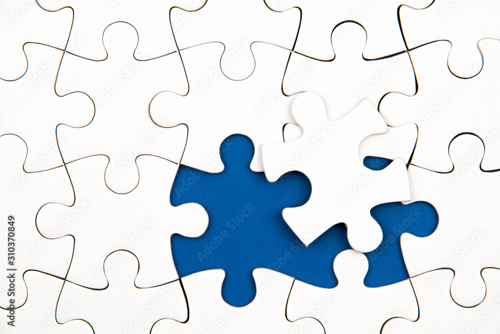 White puzzle over blue backround with missing pieces. Incomplete elements, solution search concept White puzzle over blue backround with missing pieces. Incomplete elements, solution search concept