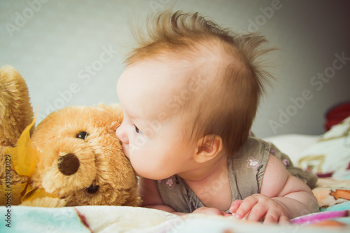 Baby plays with a teddy bear