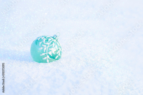 Christmas ball on the snow.