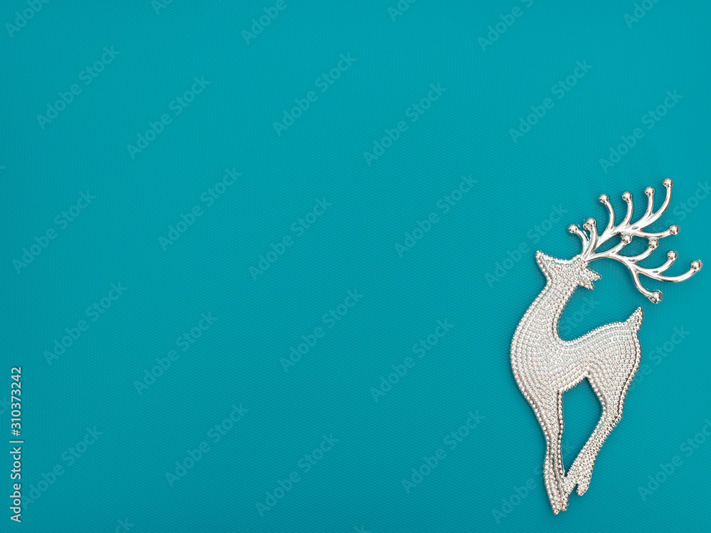 Christmas or winter blue background with one deer. New Year greeting card. Christmas, New Year or winter concept. Flat lay style with copy space.