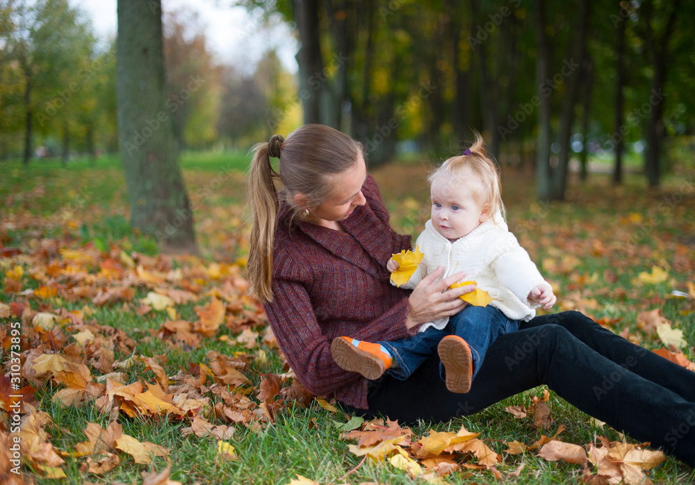 mother with child in the autumn forest for a walk mother with child in the autumn forest for a walk
