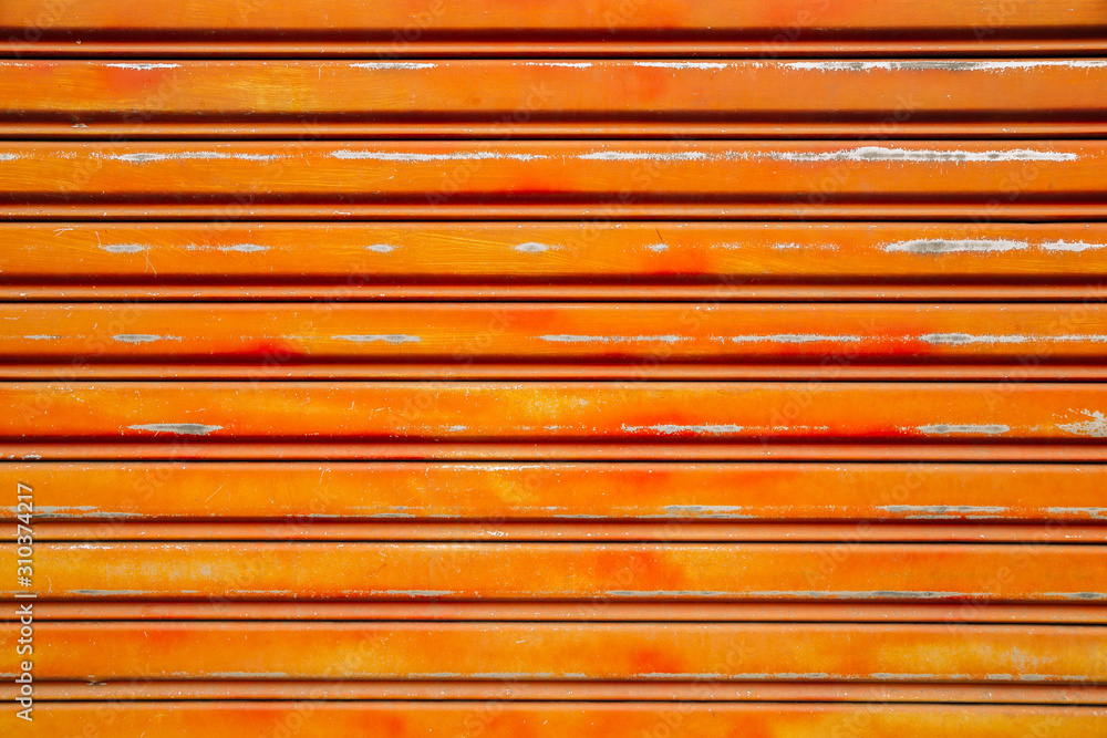 Fototapeta premium Orange metal shutter door background