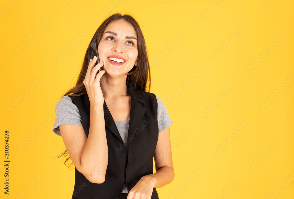 A woman standing on the telephone There is space to put text. In the yellow background A woman standing on the telephone There is space to put text. In the yellow background
