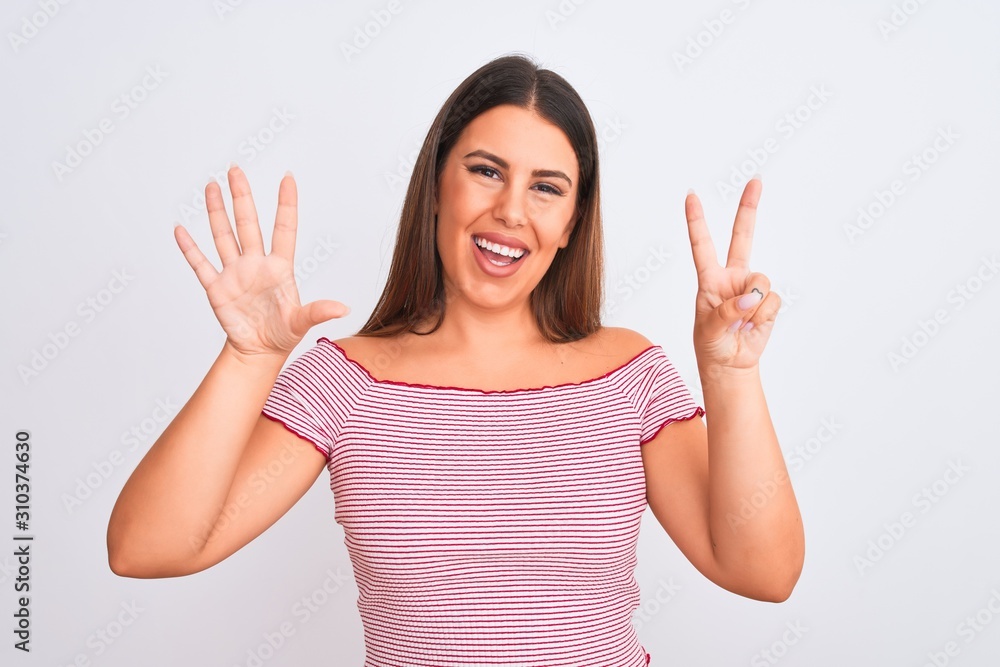 Portrait of beautiful young woman standing over isolated white background showing and pointing up with fingers number seven while smiling confident and happy. Portrait of beautiful young woman standing over isolated white background showing and pointing up with fingers number seven while smiling confident and happy.