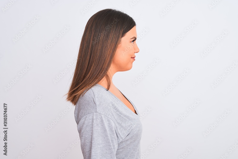 Portrait of beautiful young woman standing over isolated white background looking to side, relax profile pose with natural face with confident smile. Portrait of beautiful young woman standing over isolated white background looking to side, relax profile pose with natural face with confident smile.
