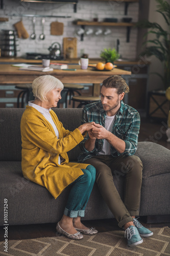 Grey-haired elderly lady feeling greatl with her son