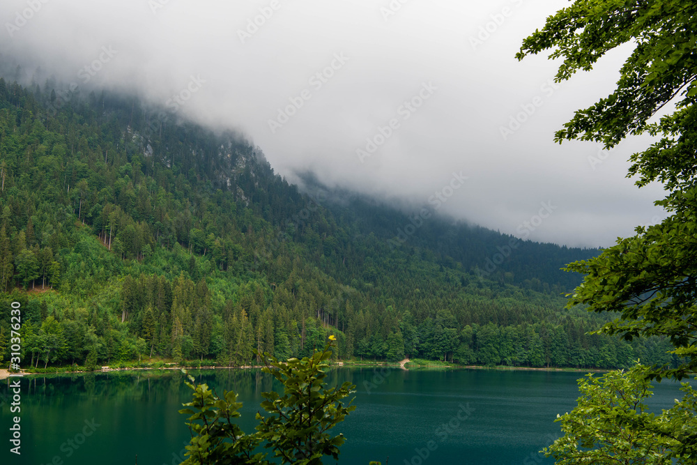 Beautiful mountain lake Alpsee - Hohenschwangau on a cloudy day, Germany