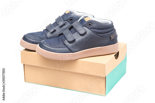 Children shoes sneakers on shoe cardboard box, isolate on white background.