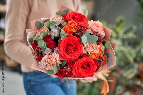 Wallpaper Mural European floral shop. Beautiful bouquet of mixed flowers in womans hands. the work of the florist at a flower shop. Delivery fresh cut flower. Torontodigital.ca