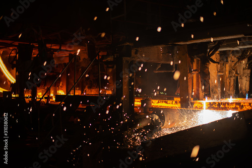 Hot red steel billets at torch cutting. Background of the blacksmith and metallurgical industry.