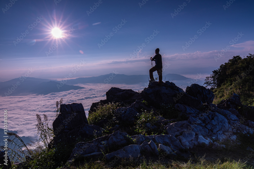 The man hiking on Doy-pha-tang, Landscape sea of mist on Mekong river in border  of  Thailand and Laos.