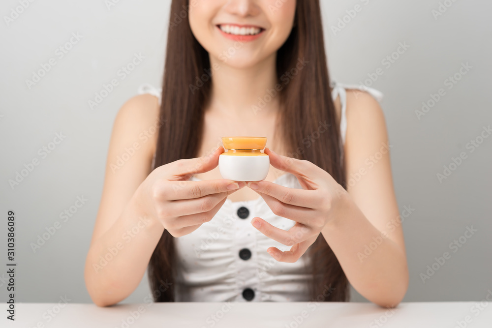 Asian woman model present showing cosmetic product. Beauty concept. Asian woman model present showing cosmetic product. Beauty concept.