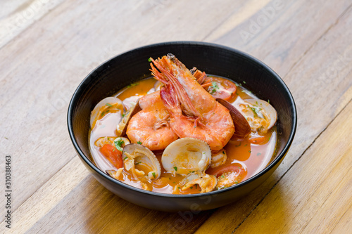 A bowl of fresh tom yum with big size prawn and clams.