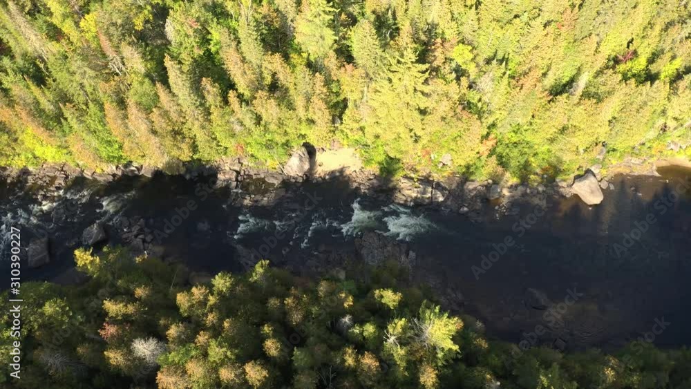 Overhead bird's eye view of a river with a few whirls created by cascade Overhead bird's eye view of a river with a few whirls created by cascade