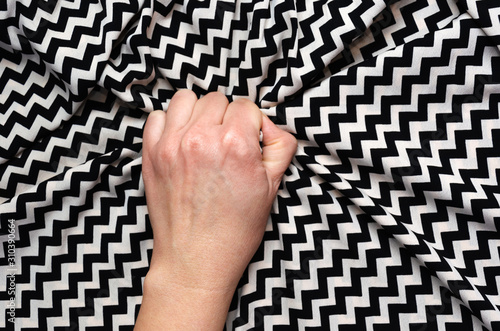 Cuadro en lienzo Female hand grasping or clutching silk bed sheet with geometric print in ecstasy