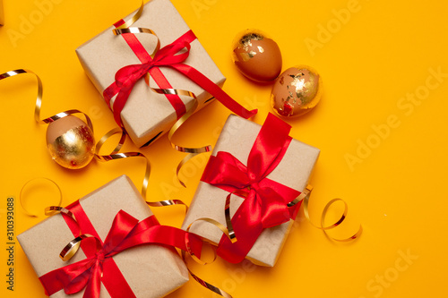 Beautiful gifts boxes with red bows and sweets on a beige background for a site, banner or article