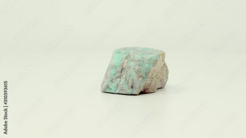 Close view of roughly cut, green-blue Amazonite mineral chunk. Rotating back to front. Close view of roughly cut, green-blue Amazonite mineral chunk. Rotating back to front.