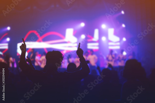 soft focus of Christian worship with raised hand music concert