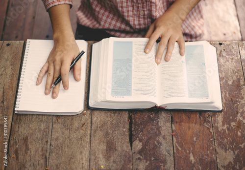 Soft focus young women prayer and read holy bible.bible study concept