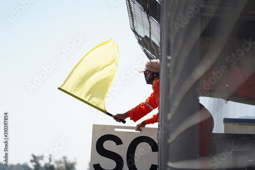 A man in yellow bogong on the racetrack photo