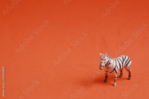 plastic toy with zebra shape in color background