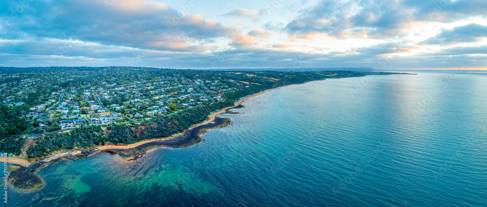 Fototapeta premium Szeroka panorama z lotu ptaka na przedmieścia Mount Eliza i wybrzeże o zachodzie słońca Melbourne, Australia