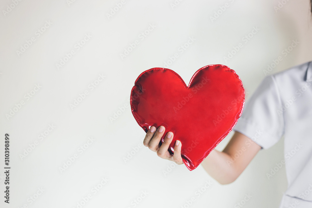 Female doctor hands holding red heart with ecg line and stethoscope,healthcare and medicine concept. Female doctor hands holding red heart with ecg line and stethoscope,healthcare and medicine concept.