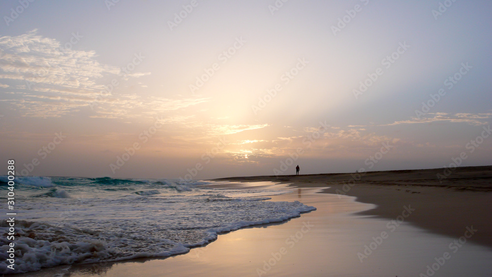 person enjoying an evening walk on a secluded tropical beach in Cape Verde at sunset