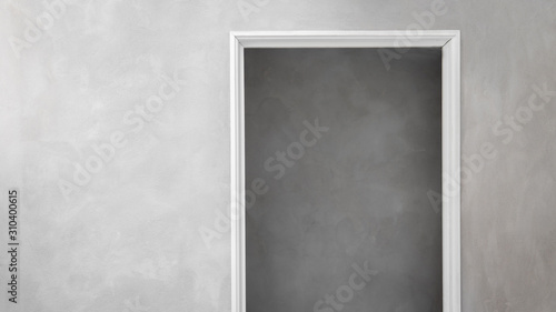 Industrial design concrete walls with minimalist white door frame looking into concrete building.