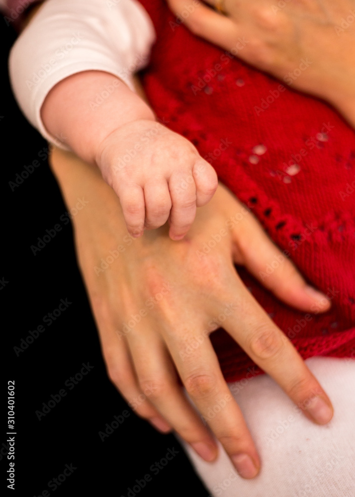 Hand of a little girl and parents