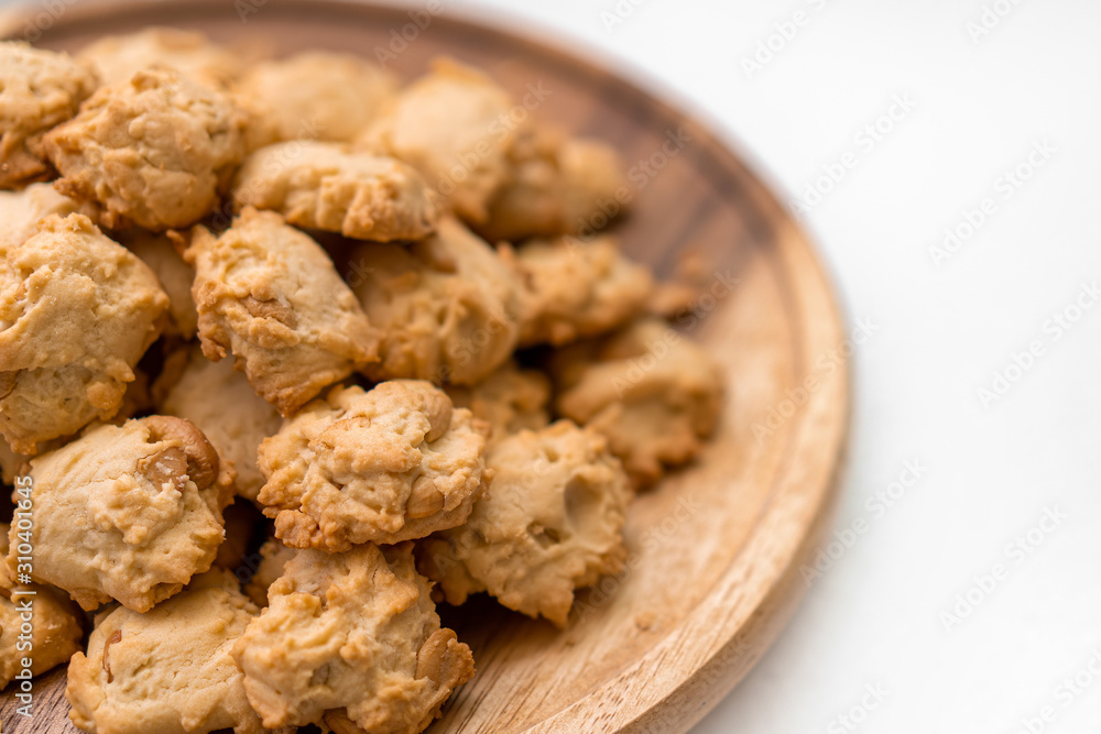 Cashews cookies on wooden plate isolate on white background. Cashews cookies on wooden plate isolate on white background.