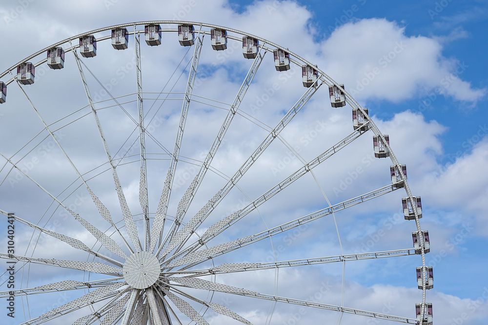 abstract background with ferris wheel on a background of blue sky with clouds
