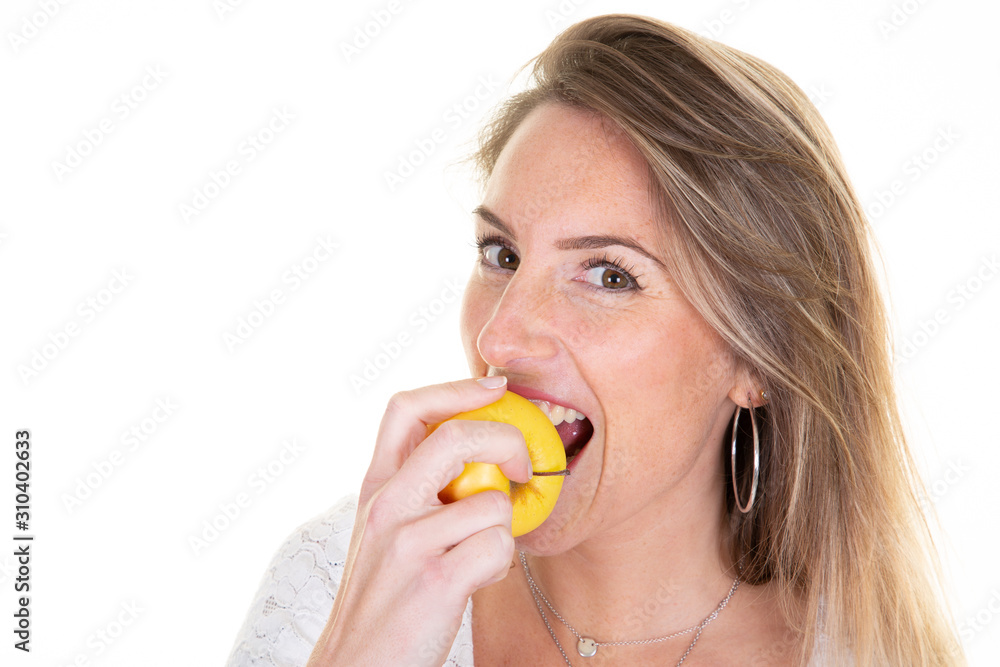 Portrait of cheerful young blonde woman eating bitting yellow apple Portrait of cheerful young blonde woman eating bitting yellow apple