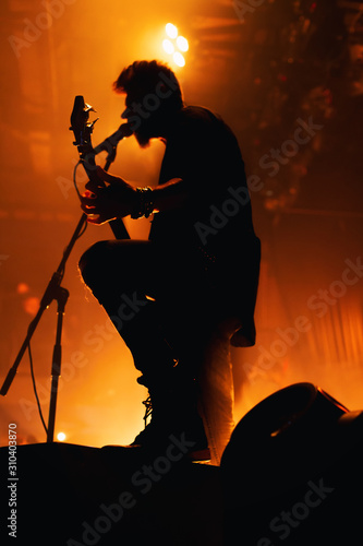 Silhouette of a musician on the stage of a night club.